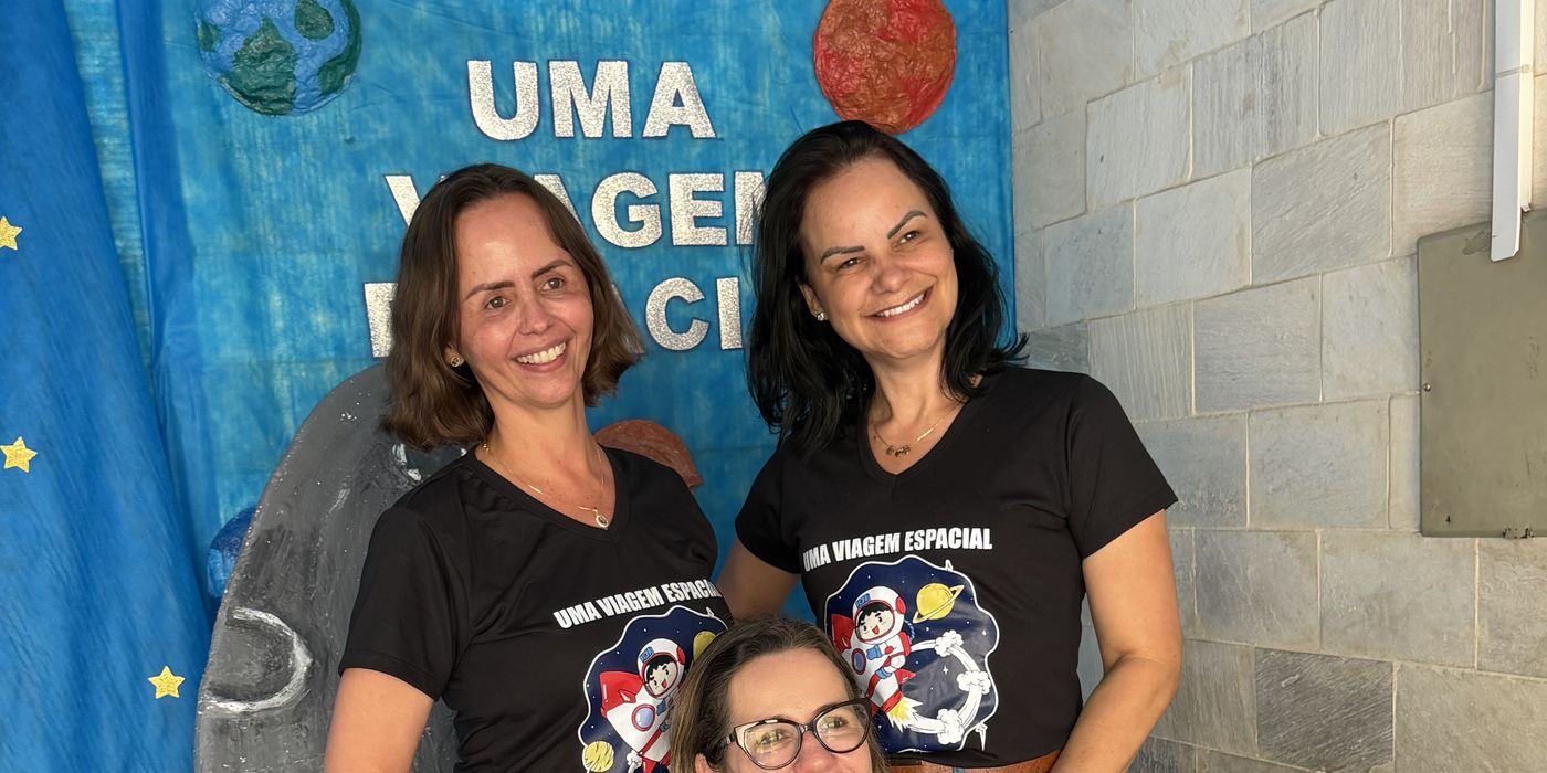 Professora Mariene com apoiadoras em evento de ciências numa escola